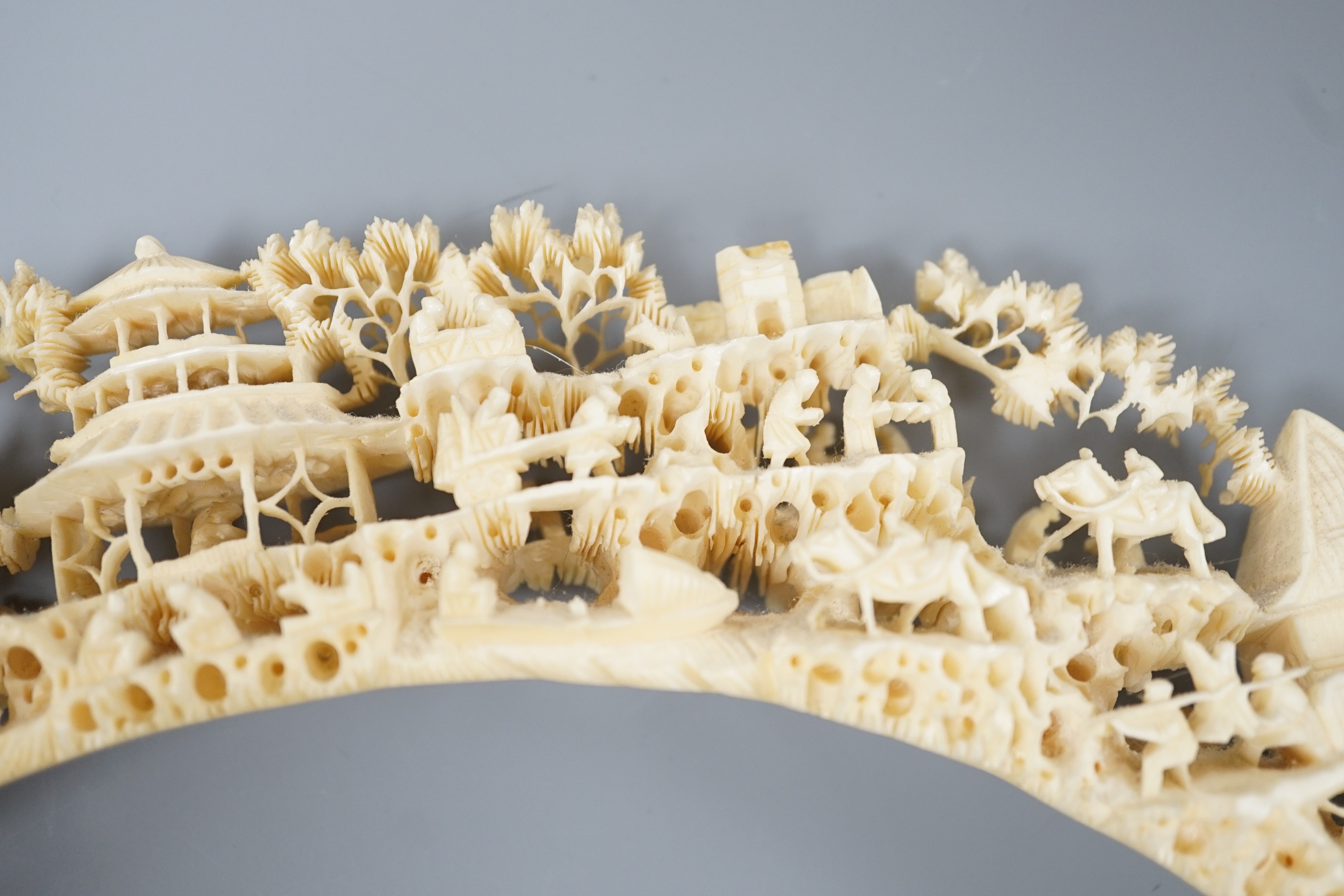 An early 20th century Chinese ivory ‘dragon’ box and cover, and a boar’s tusk carving of figures amid pavilions 40cm